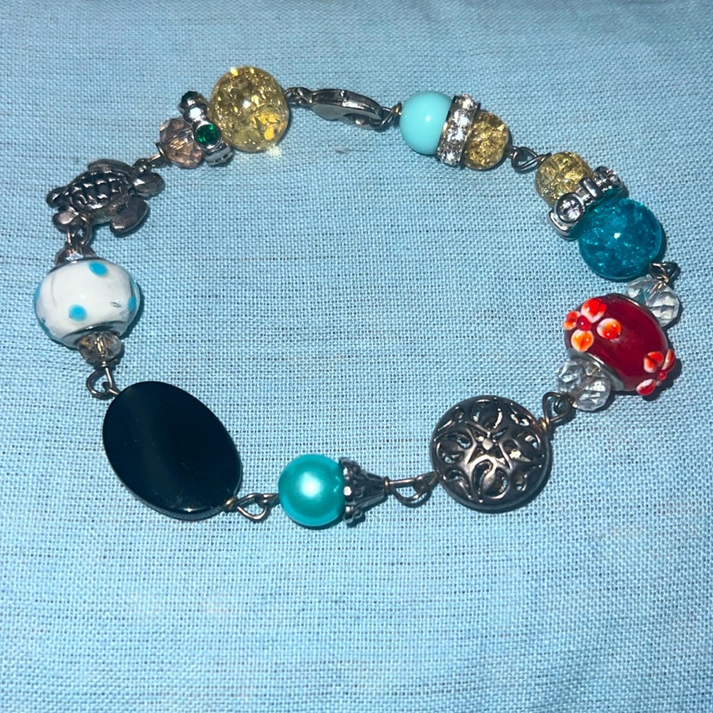 This is a beach themed bracelet with a clasp.